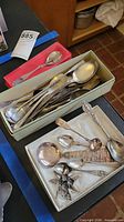 Grouped view of spoons in two boxes showing quantity and variety