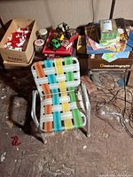Overall view with chair, board games, vehicles, jar of marbles, building bricks box