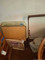 Stacked folding TV trays, laminate tops, metal legs, leaning against wall with metal stand visible