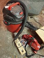 Craftsman shop vac, Dirt Devil hand vac, belts, goggles visible