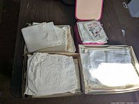 Overview of three boxes of folded vintage linens