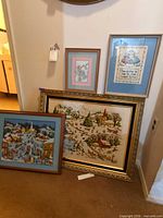 Group shot of all four framed textile pictures leaning against wall