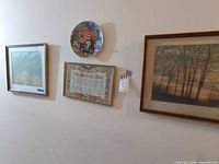 All three framed prints and Knowles plate mounted on wall