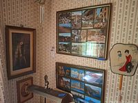Corner view showing four framed artworks and wind chime