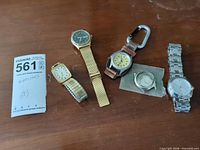 Five assorted watches displayed together with lot tag