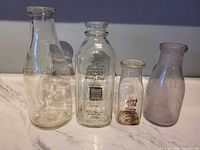 Group shot of all four milk bottles