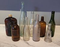 Group shot of all nine vintage glass bottles