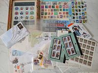 Group shot showing variety of sheets, booklets, loose stamps and covers
