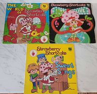 Three Strawberry Shortcake LP jackets laid out