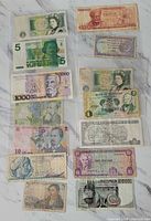 Fronts of fifteen assorted world banknotes laid out