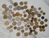 All 87 coins spread on marble background
