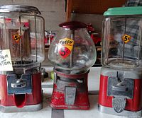 Three countertop gumball machines showing coin mechanisms and 5¢ decals