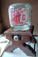 Front view of glass globe on wooden base showing branding and mechanism