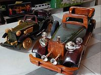 Both wooden model cars front three-quarter view