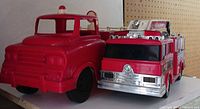 Front and partial side view of both fire truck toys