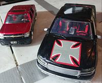 Front three-quarter view of both trucks showing paint schemes and interiors