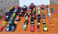 Top view entire assortment of 50 die-cast vehicles arranged in rows