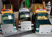 Front view of all three Nylint tow trucks aligned