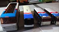 Front view of all four toy buses lined up