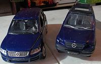 Front view of Volkswagen and Mercedes diecast SUVs