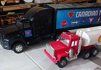Black Canadian Tire semi and red Shell semi side by side