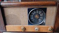 front view showing speaker grille, dial and control knobs