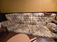 Front view of entire three-seat floral sofa