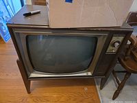 Front view of Admiral console CRT TV showing screen, faceplate, controls, and speaker grille