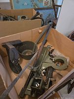 Box containing ladle, scoop, green fixture, auger bit, rods