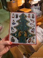 Boxed slotted wooden tree with mini ornaments visible in packaging