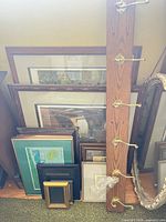 Group of framed prints, wall rack with brass hooks, gilt mirror