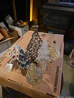 Assorted tabletop trees grouped together on box