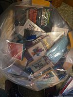 Plastic bag containing multiple paperback books with visible titles