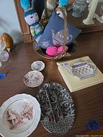 Overview of lot on dresser showing keys, plates, teapot dish box, brass basket with pincushion