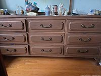 Front view of dresser showing nine drawers and handles