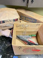 Overall view with boxes of nails, Dixie Apparatus sleeve, carton of hand tools