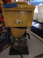 Full view of coffee maker with carafe on base