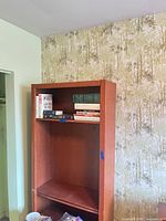 Full view tall bookcase with shelf of books