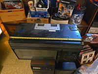 Top view of GE Spacemaker microwave with measuring tape showing width; visible wear on surface