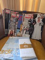 Front view of magazine stack, tea towel, face cloth