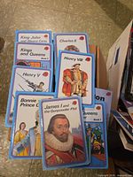 Stack of blue-border Ladybird Kings and Queens series showing eight distinct monarch titles