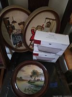 Group shot of embroideries, plaque and boxed casseroles