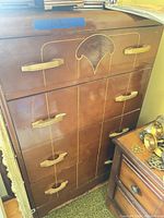 Front view showing five drawers, pulls, decorative inlay