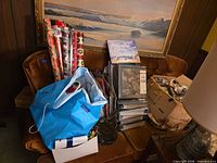 Full view of brown velvet armchair partially obscured by miscellaneous items