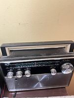 Front view of Minerva portable radio showing controls and handle