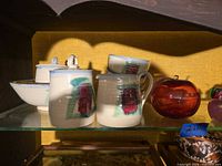 Studio pottery pieces with glass apple to right