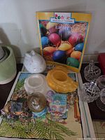 Group showing book, planters, rabbit planter, yellow dish, snow globe, two crystal containers