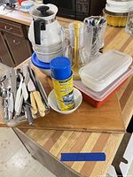 Group view showing percolator, plastic containers, flatware basket