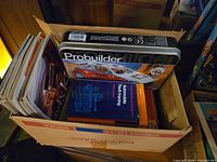 Box with manuals, magazines and Mega Bloks tin