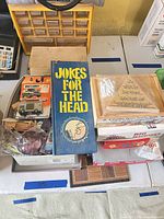 Stack showing book, wooden puzzles, Matchbox car, Bingo game, loose toys